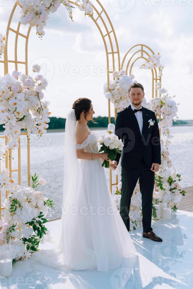wedding ceremony of the newlyweds on the pier photo