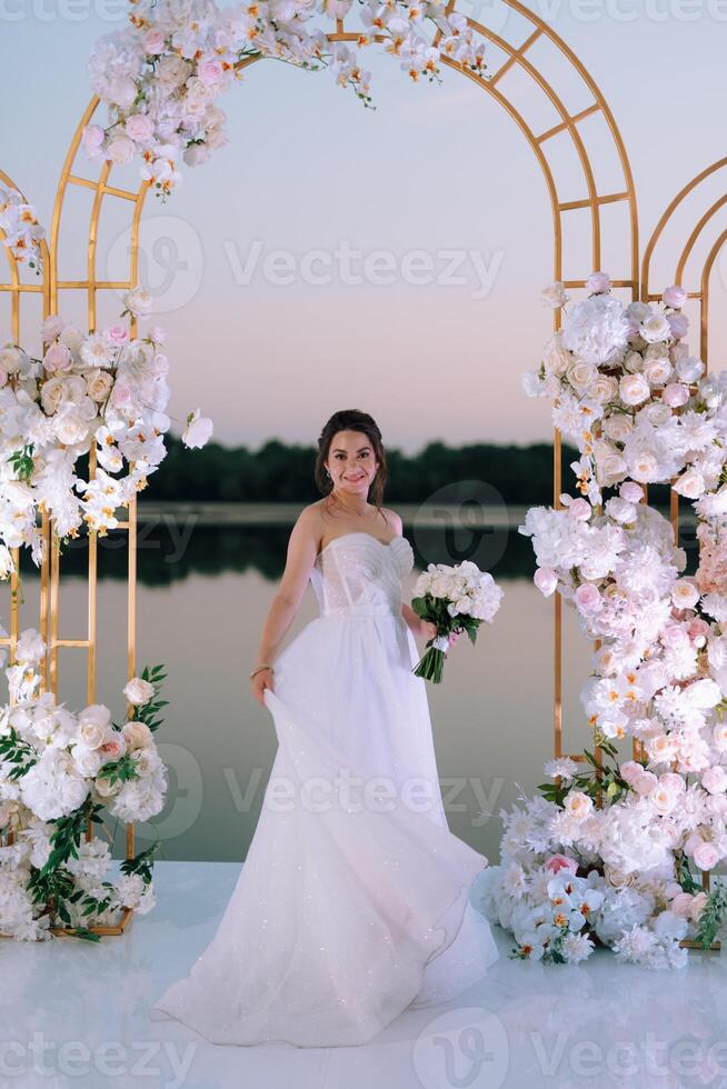 bride against the background of a yellow sunset photo