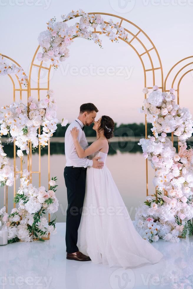 bride and groom against the backdrop of a yellow sunset photo