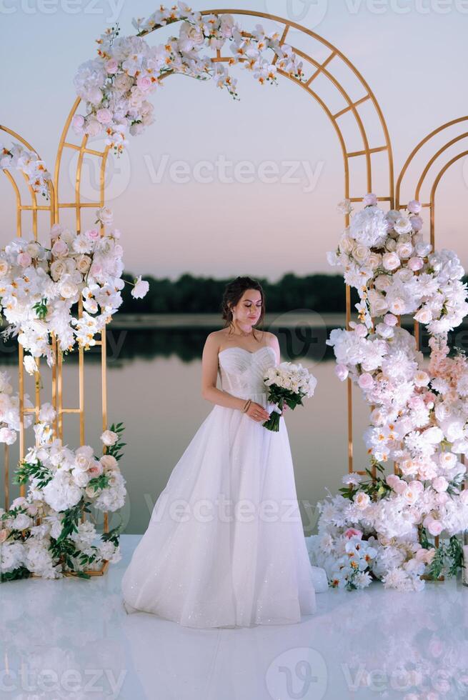 bride against the background of a yellow sunset photo