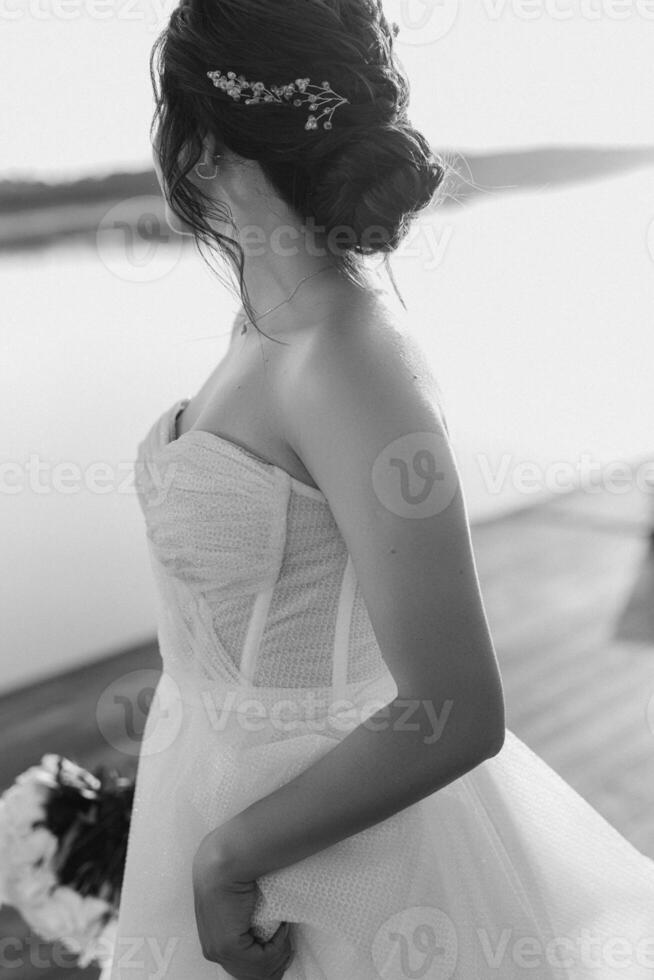 bride against the background of a yellow sunset photo