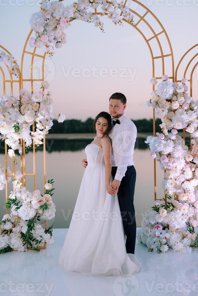 bride and groom against the backdrop of a yellow sunset photo