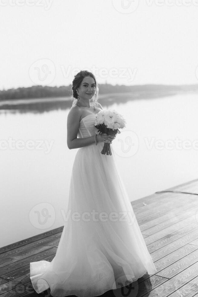 bride against the background of a yellow sunset photo