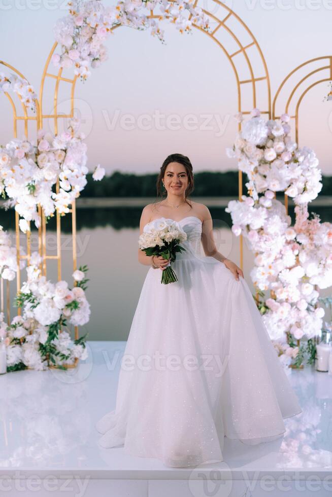 bride against the background of a yellow sunset photo