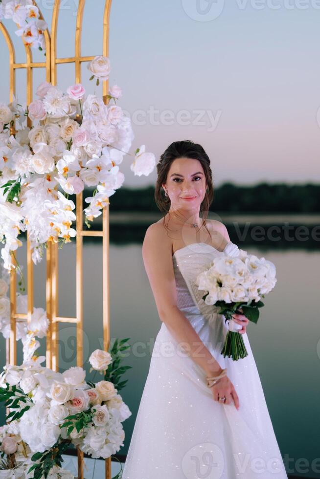 bride against the background of a yellow sunset photo