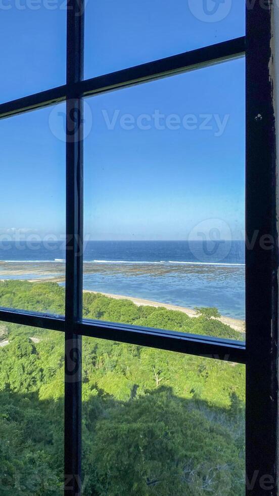 Ocean View Through Window with Tropical Trees photo
