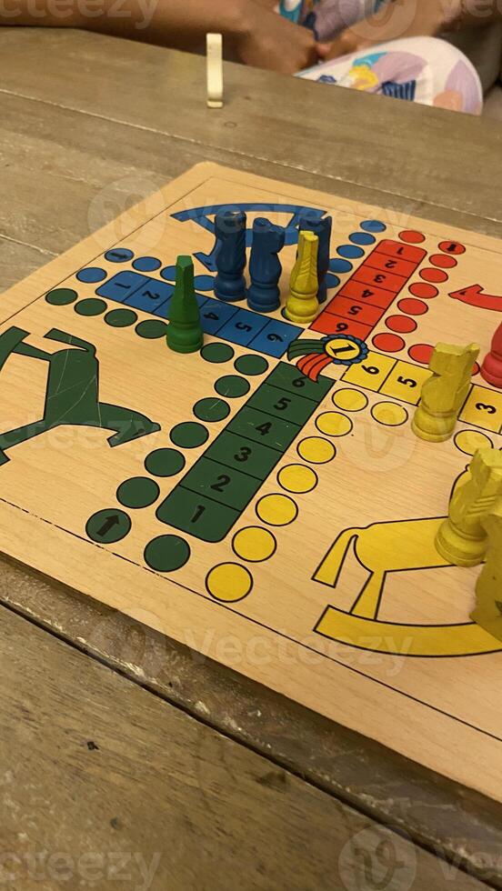 Ludo Game in Progress on Wooden Table photo
