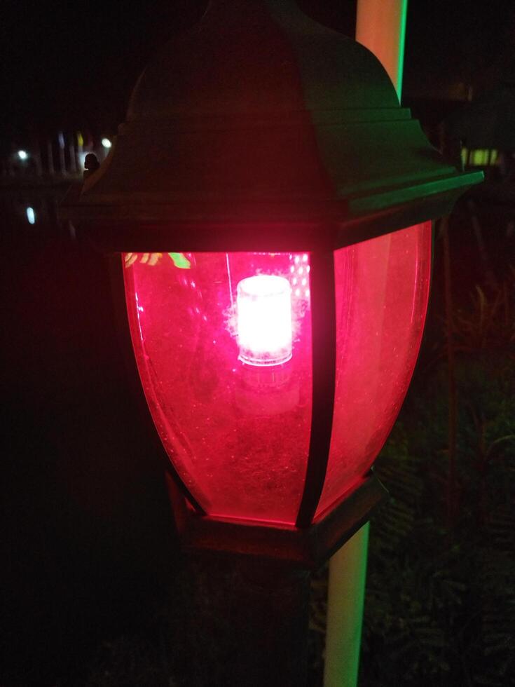 a red light is on a street light photo