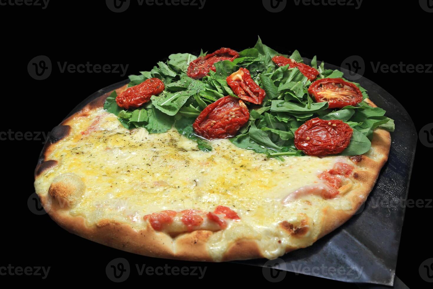 Brazilian pizza with each half with different flavors and toppings coming out of the oven photo