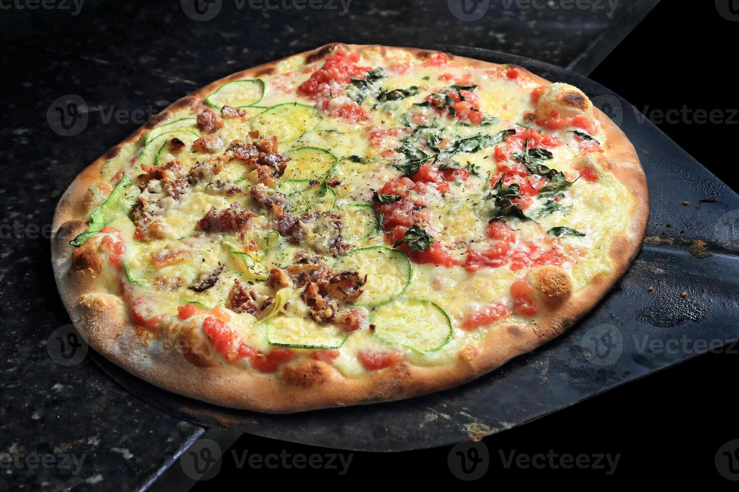 Brazilian pizza with each half with different flavors and toppings coming out of the oven photo