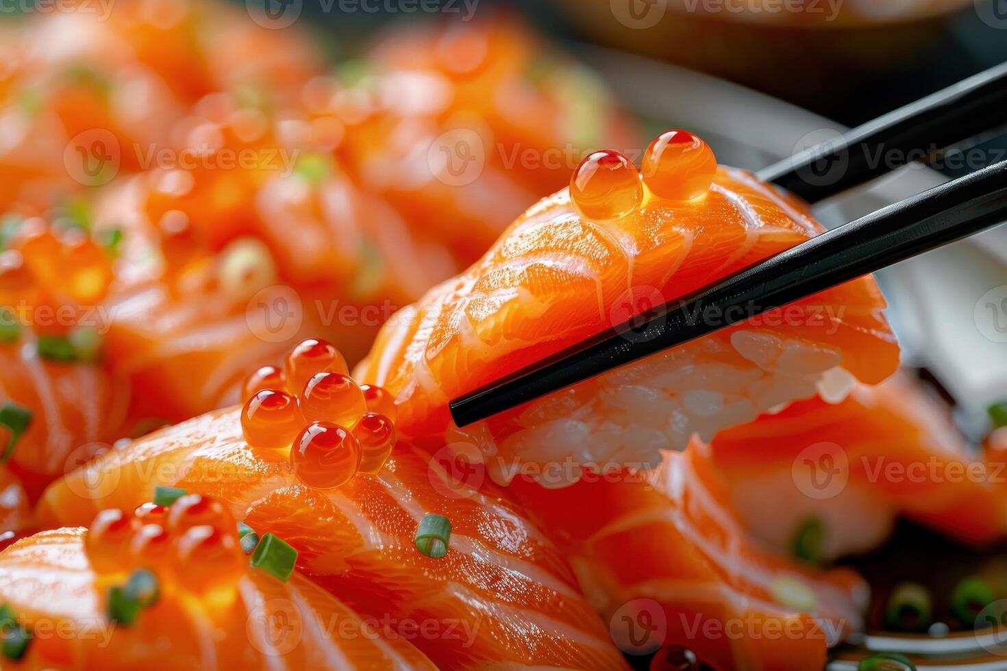 A plate of sushi with chopsticks in hand photo