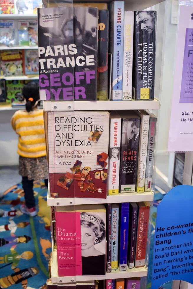 New Delhi, India, June 25 2024 - Variety of Books on shelf inside a book-stall at Delhi International Book Fair, Selection of books on display in Annual Book Fair at Bharat Mandapam complex photo