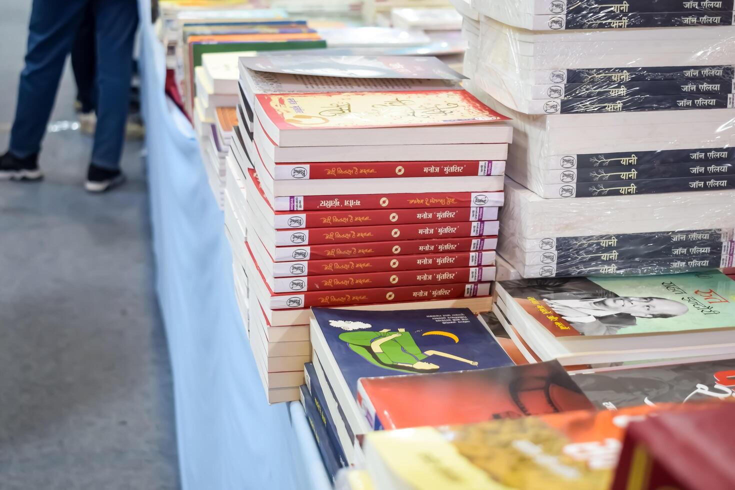 New Delhi, India, February 17 2024 - Variety of Books on shelf inside a book-stall at Delhi International Book Fair, Selection of books on display in Annual Book Fair at Bharat Mandapam complex photo