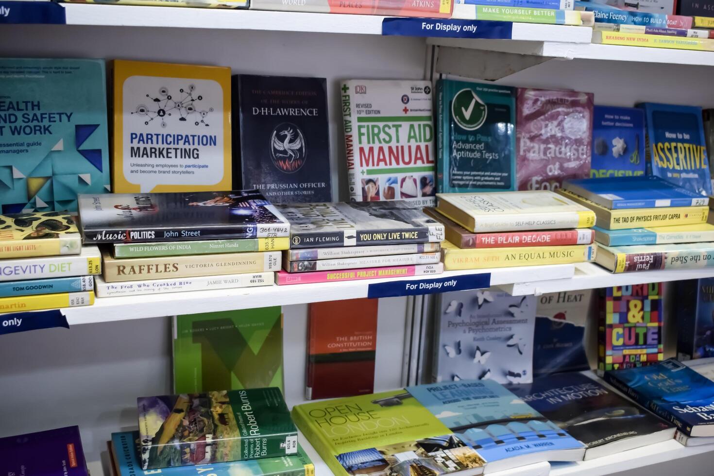 New Delhi, India, February 17 2024 - Variety of Books on shelf inside a book-stall at Delhi International Book Fair, Selection of books on display in Annual Book Fair at Bharat Mandapam complex photo