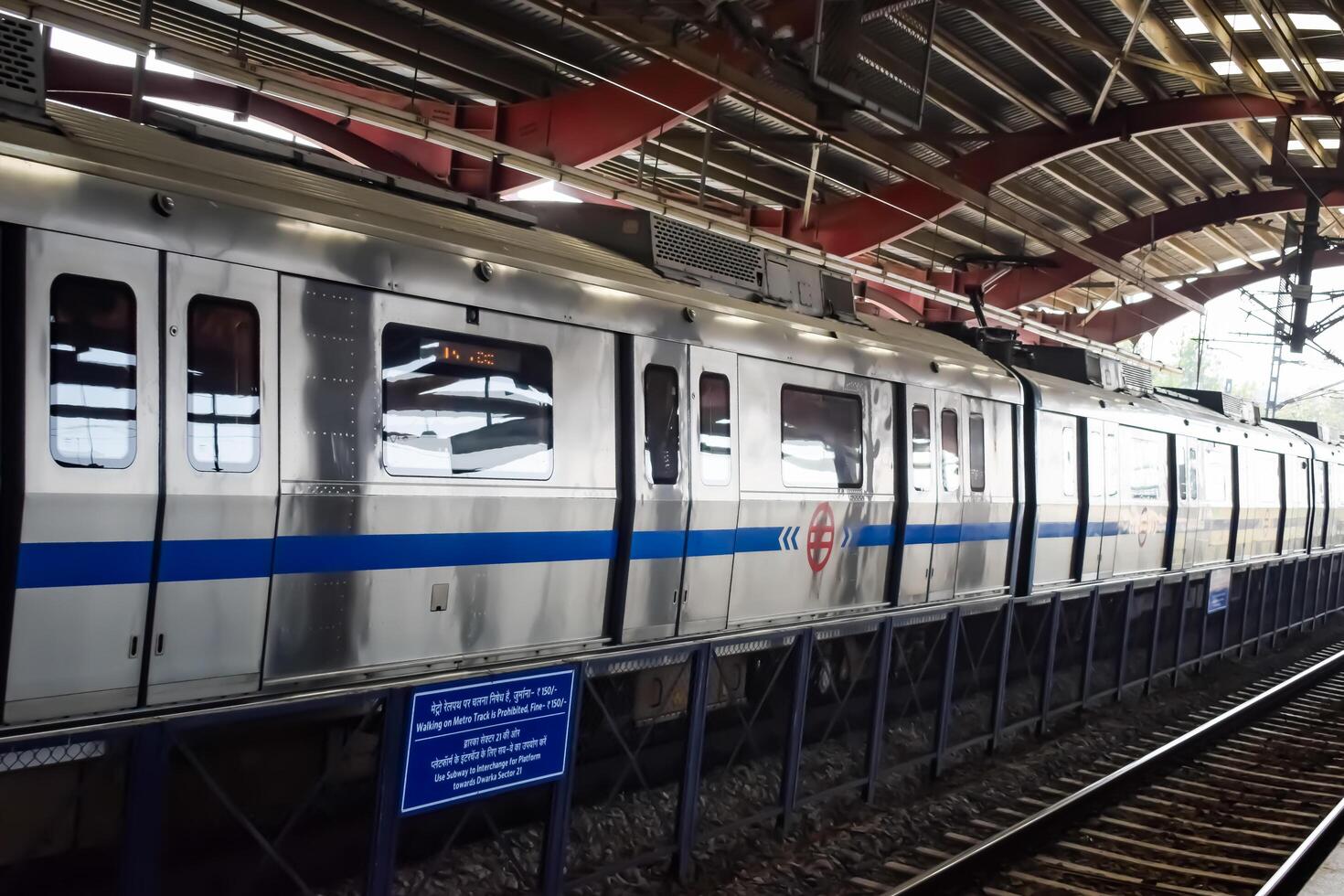 New Delhi, India, June 12 2024 - Delhi Metro train arriving at Jhandewalan metro station in New Delhi, India, Asia, Public Metro departing from Jhandewalan station photo