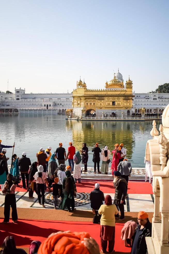 Amritsar, India -June 20 2024 - Unidentified devotees from various parts at Golden Temple -Harmandir Sahib in Amritsar, Punjab, India, Famous indian sikh landmark, Golden Temple photo