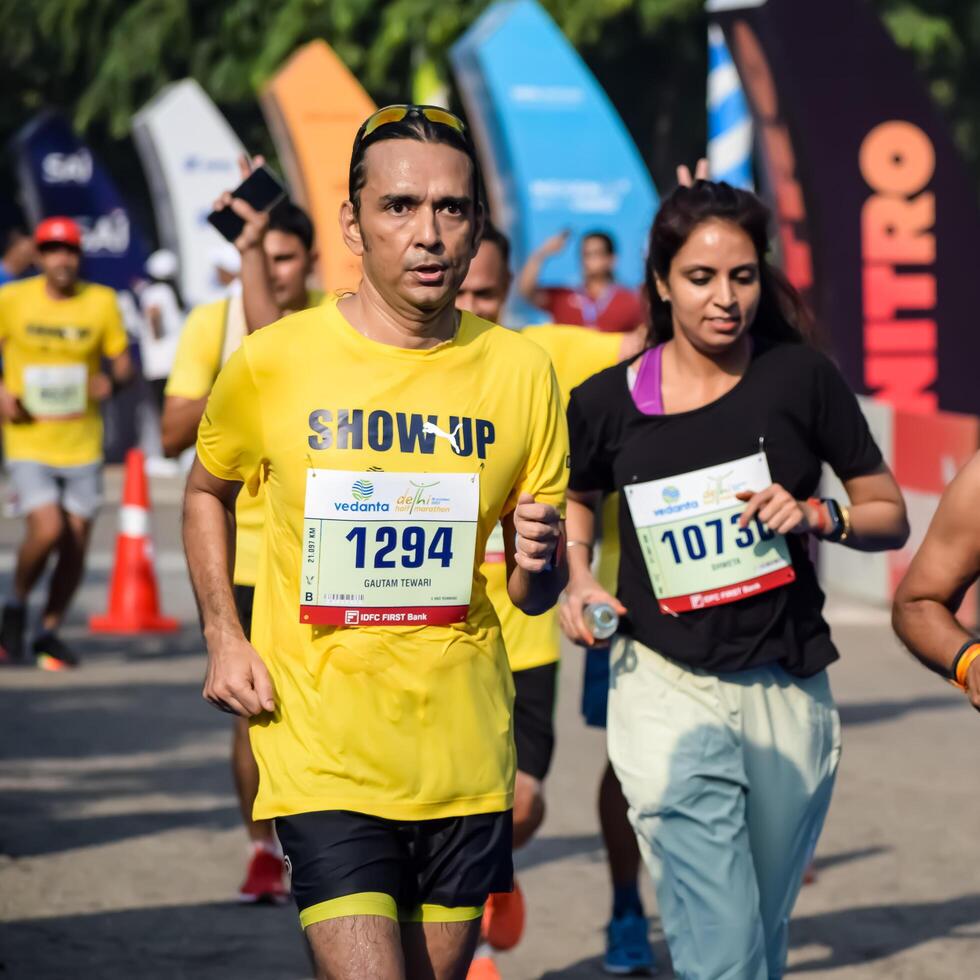 New Delhi, India - June 15 2024 - Vedanta Delhi Half Marathon race after covid in which marathon participants about to cross the finish line, Delhi Half Marathon 2023 photo