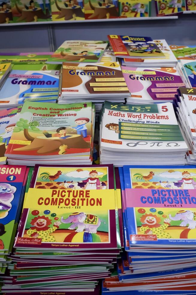 New Delhi, India, June 17 2024 - Variety of Books on shelf inside a book-stall at Delhi International Book Fair, Selection of books on display in Annual Book Fair at Bharat Mandapam complex photo