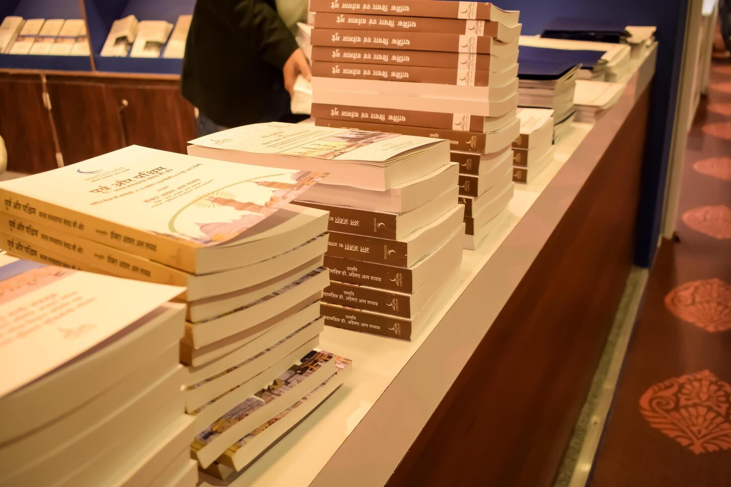 New Delhi, India, June 17 2024 - Variety of Books on shelf inside a book-stall at Delhi International Book Fair, Selection of books on display in Annual Book Fair at Bharat Mandapam complex photo