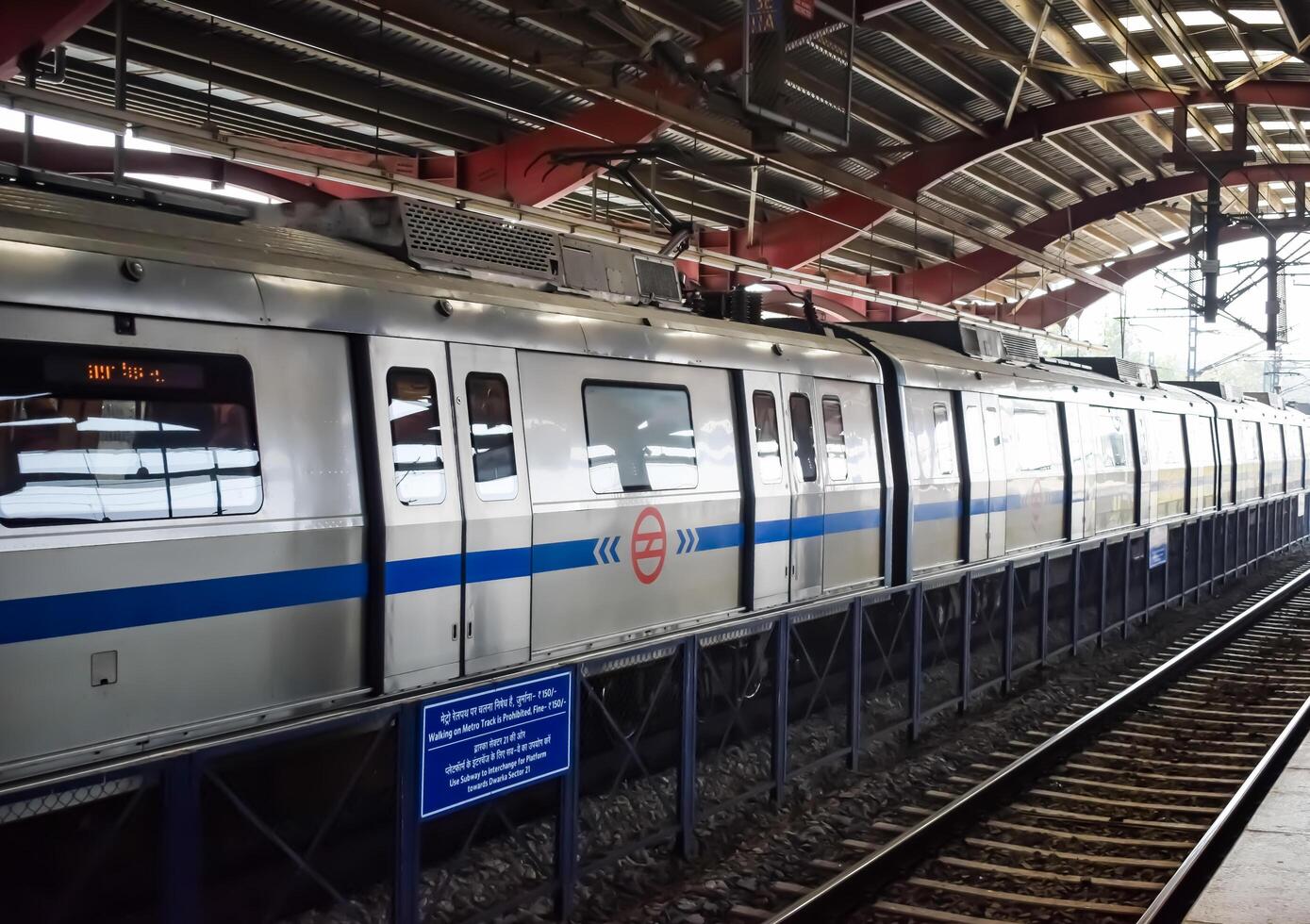 New Delhi, India, June 12 2024 - Delhi Metro train arriving at Jhandewalan metro station in New Delhi, India, Asia, Public Metro departing from Jhandewalan station photo