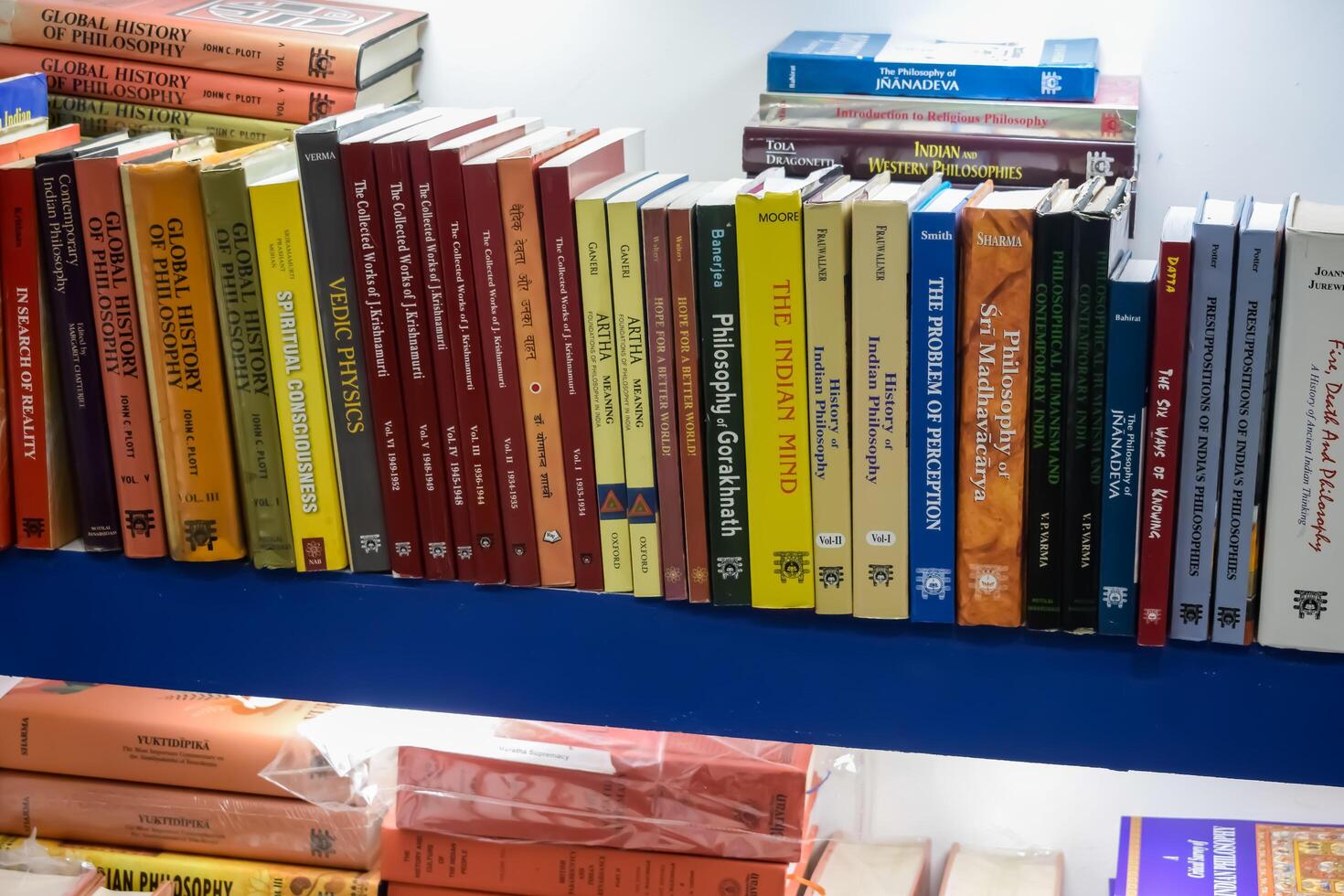New Delhi, India, June 17 2024 - Variety of Books on shelf inside a book-stall at Delhi International Book Fair, Selection of books on display in Annual Book Fair at Bharat Mandapam complex photo