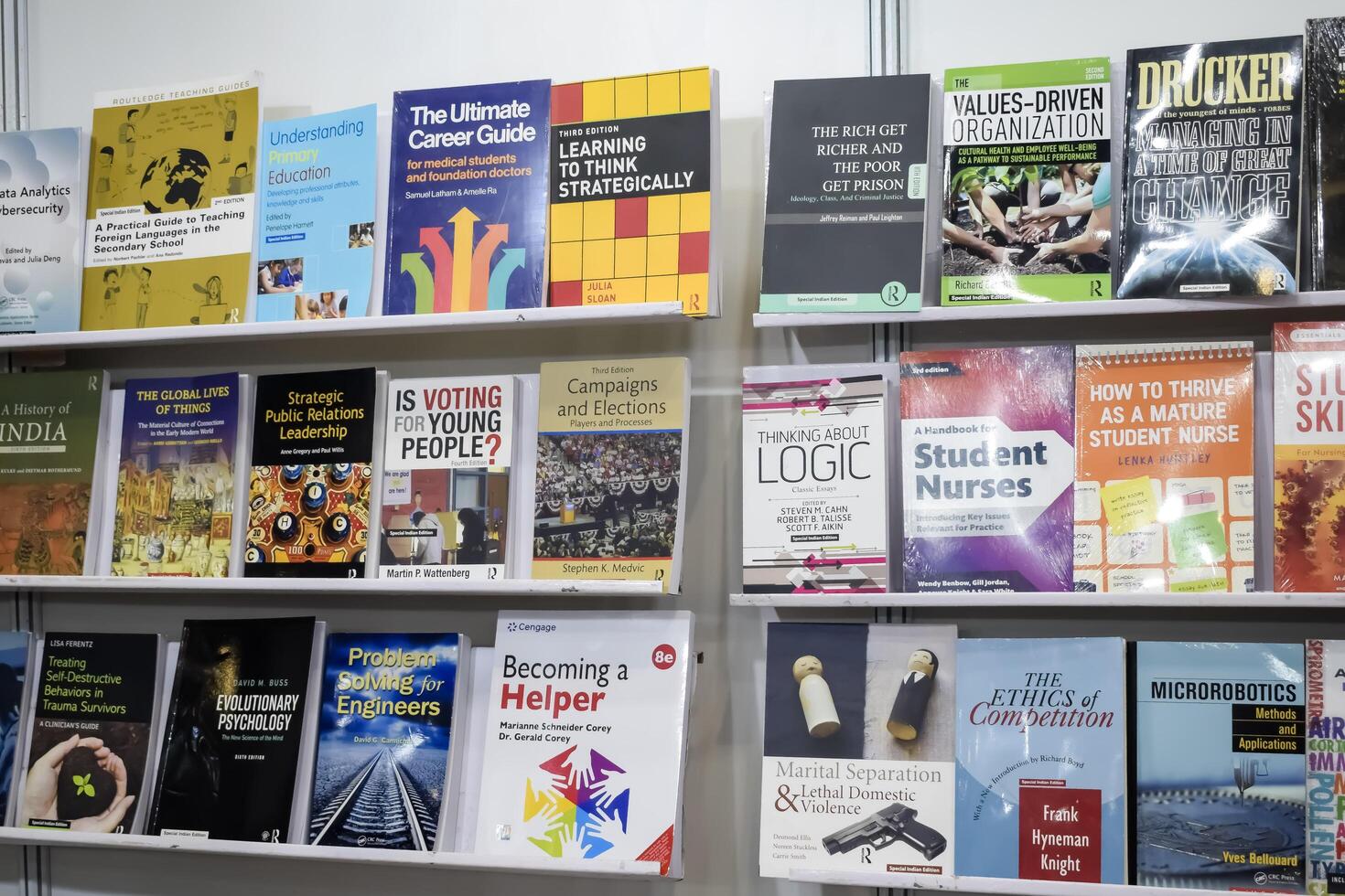 New Delhi, India, June 17 2024 - Variety of Books on shelf inside a book-stall at Delhi International Book Fair, Selection of books on display in Annual Book Fair at Bharat Mandapam complex photo