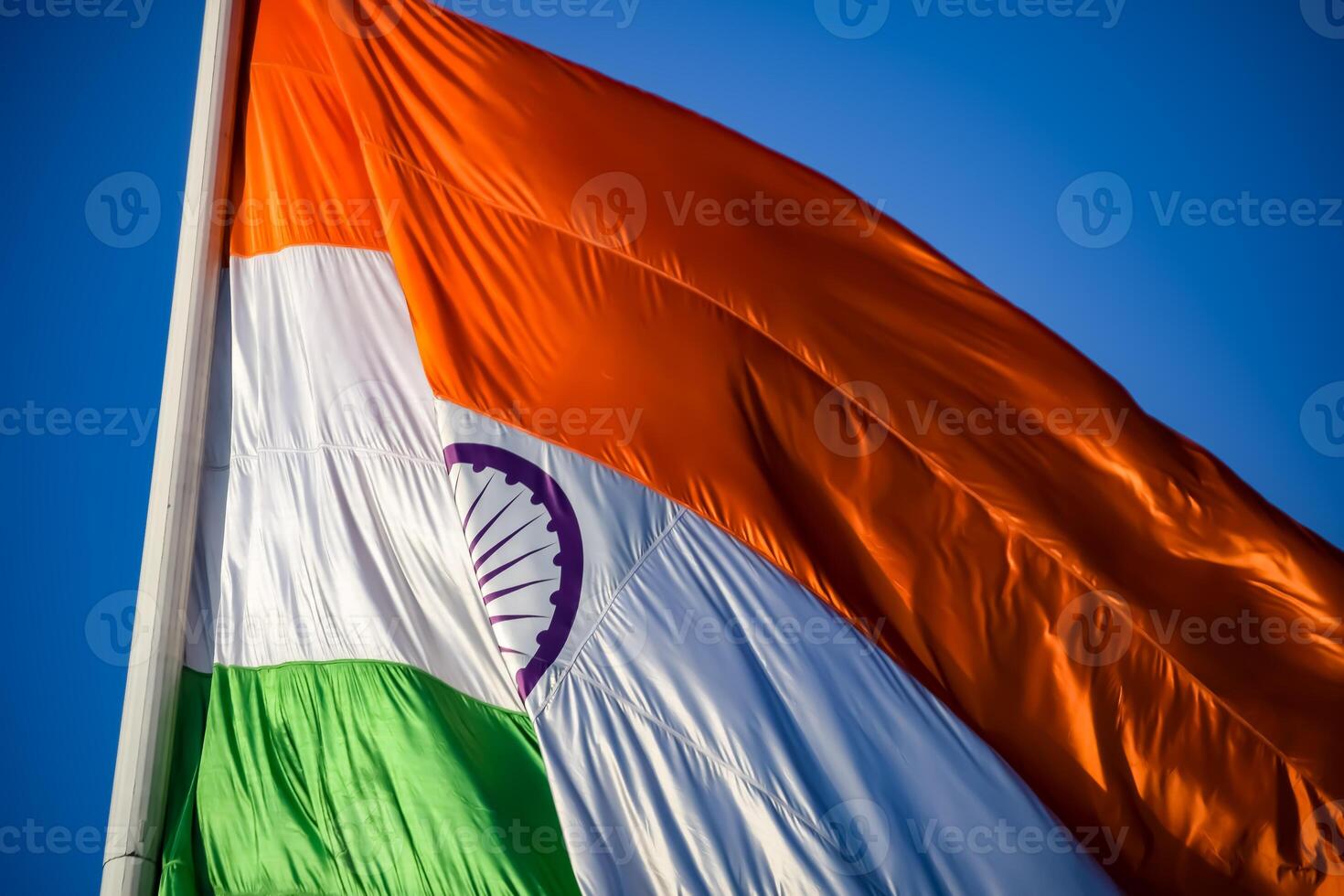 India flag flying high at Connaught Place with pride in blue sky, India flag fluttering, Indian Flag on Independence Day and Republic Day of India, tilt up shot, Waving Indian flag, Har Ghar Tiranga photo