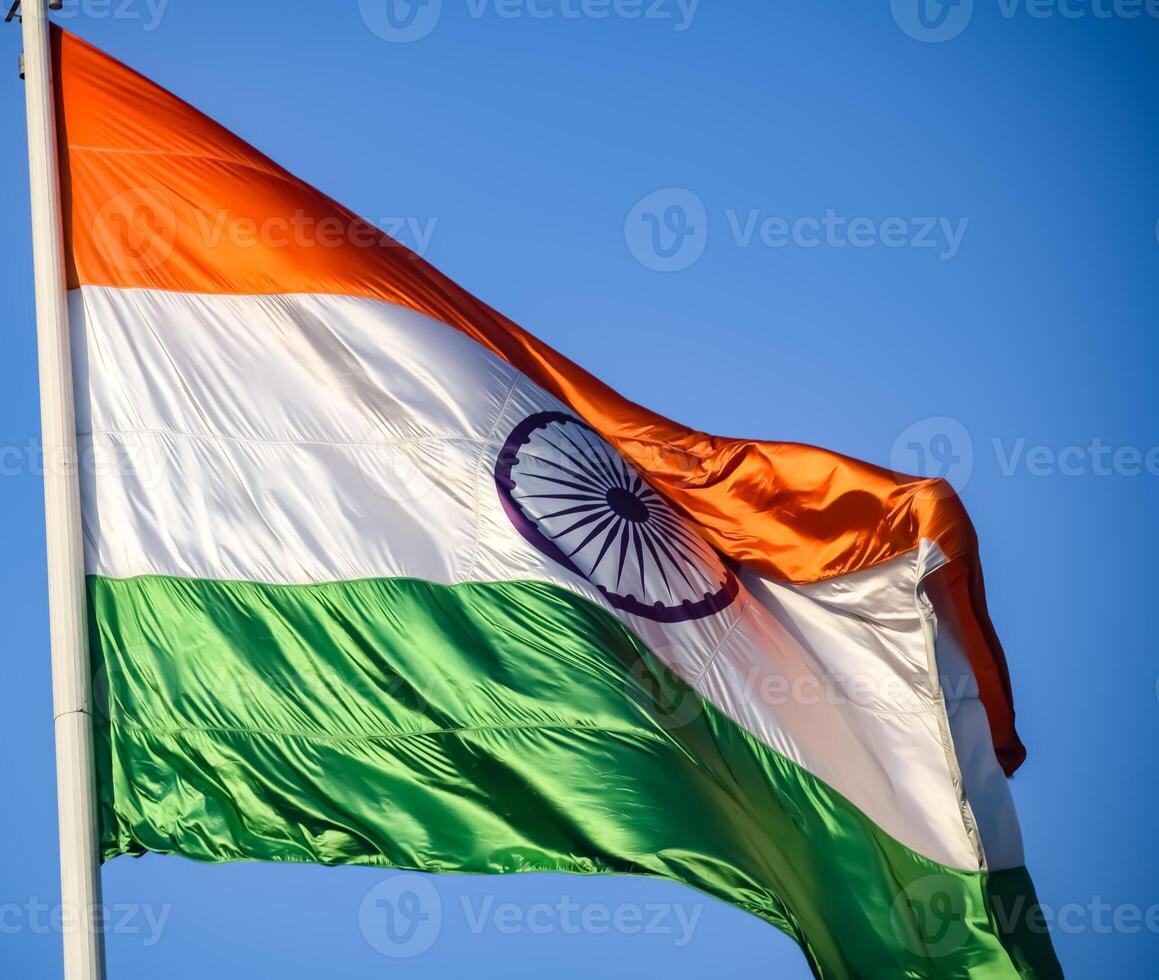 India flag flying high at Connaught Place with pride in blue sky, India flag fluttering, Indian Flag on Independence Day and Republic Day of India, tilt up shot, Waving Indian flag, Har Ghar Tiranga photo