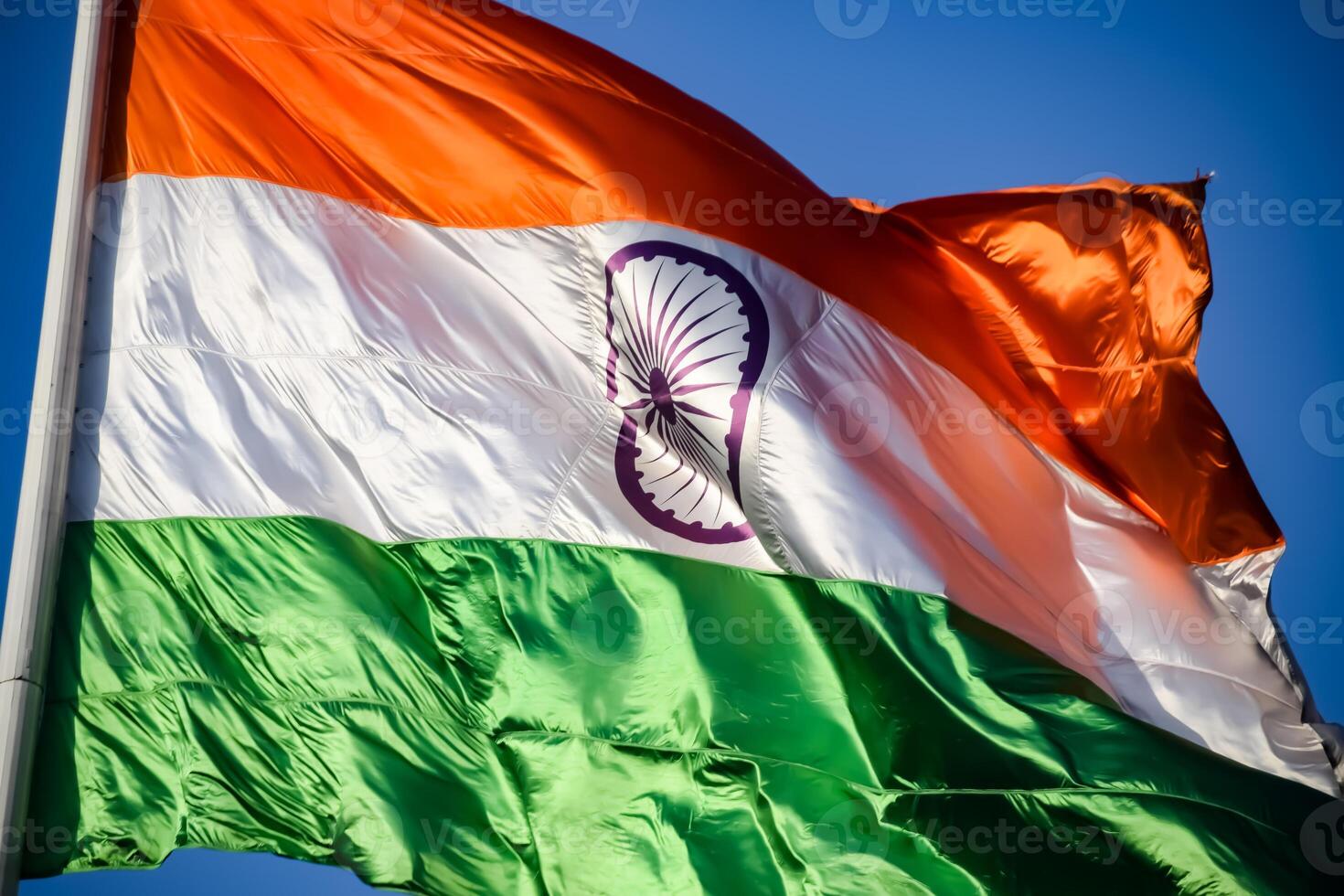 India flag flying high at Connaught Place with pride in blue sky, India flag fluttering, Indian Flag on Independence Day and Republic Day of India, tilt up shot, Waving Indian flag, Har Ghar Tiranga photo