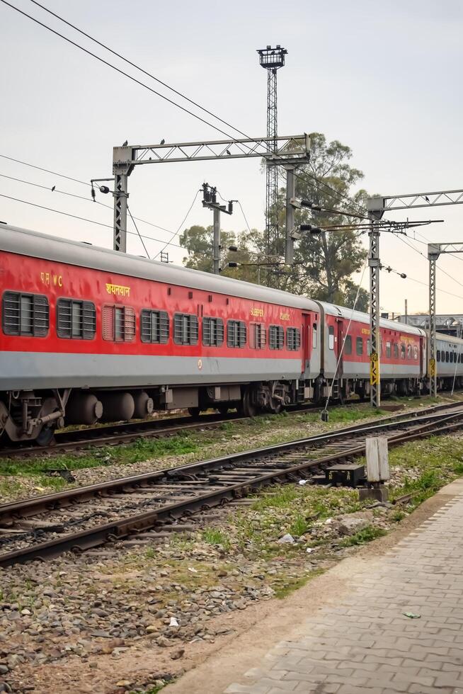 Amritsar, India, June 03 2024 - Indian railway train at Amritsar railway station platform during morning time, Colourful train at Amritsar, Punjab railway station photo