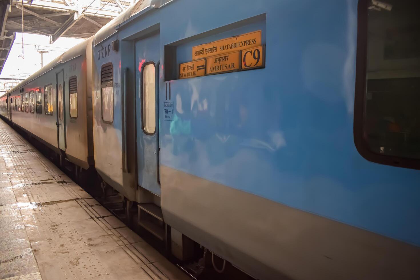 Amritsar, India, June 03 2024 - Indian railway train at Amritsar railway station platform during morning time, Colourful train at Amritsar, Punjab railway station photo