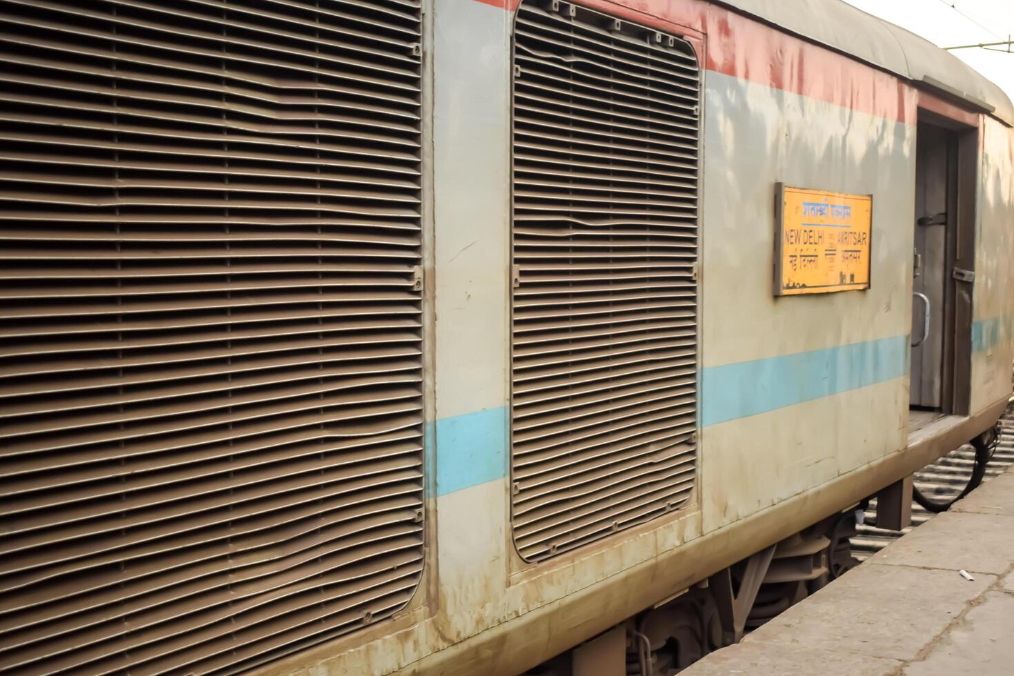 Amritsar, India, June 03 2024 - Indian railway train at Amritsar railway station platform during morning time, Colourful train at Amritsar, Punjab railway station photo