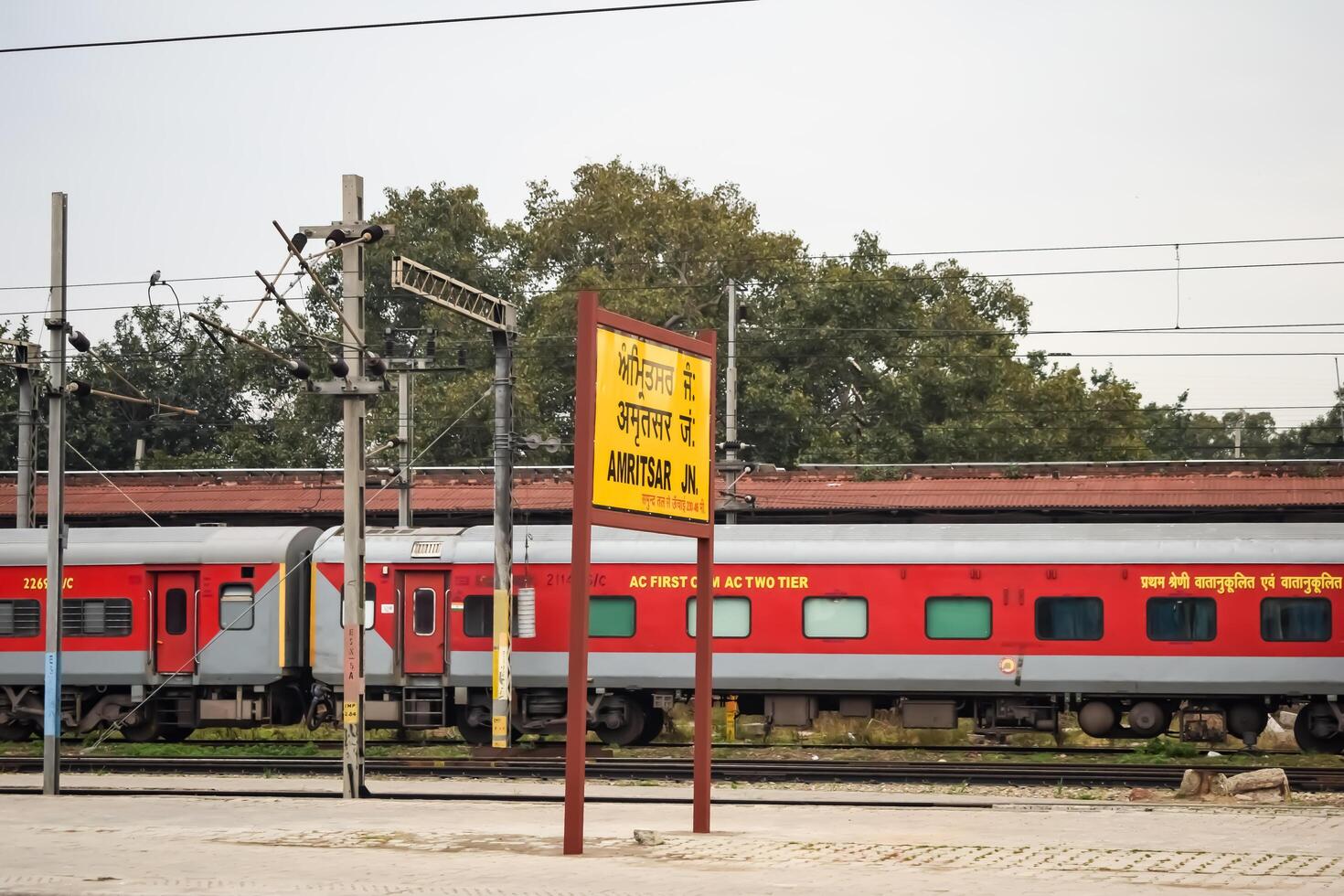 Amritsar, India, June 03 2024 - Indian railway train at Amritsar railway station platform during morning time, Colourful train at Amritsar, Punjab railway station photo