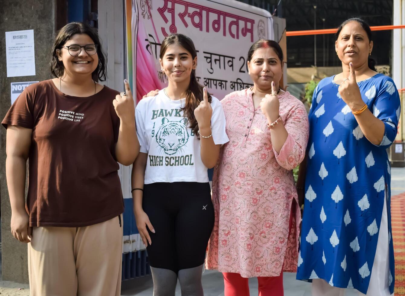New Delhi, India - May 25 2024 - Unidentified people showing their ink-marked fingers after casting votes in front of polling booth of east Delhi area for general Lok Sabha Elections 2024 photo