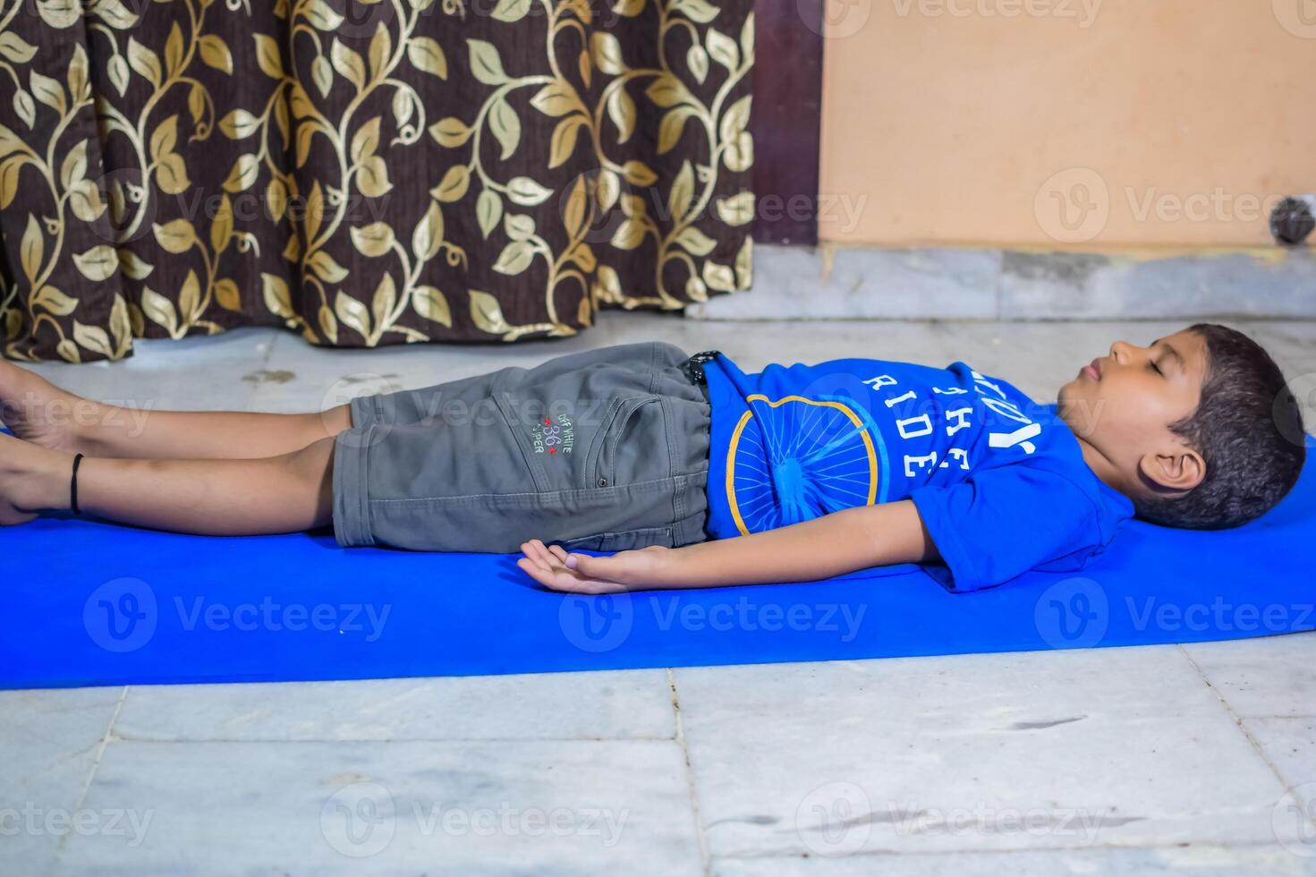 Asian smart kid doing yoga pose indoor, Children's yoga pose. The little boy doing Yoga and meditation exercise. photo