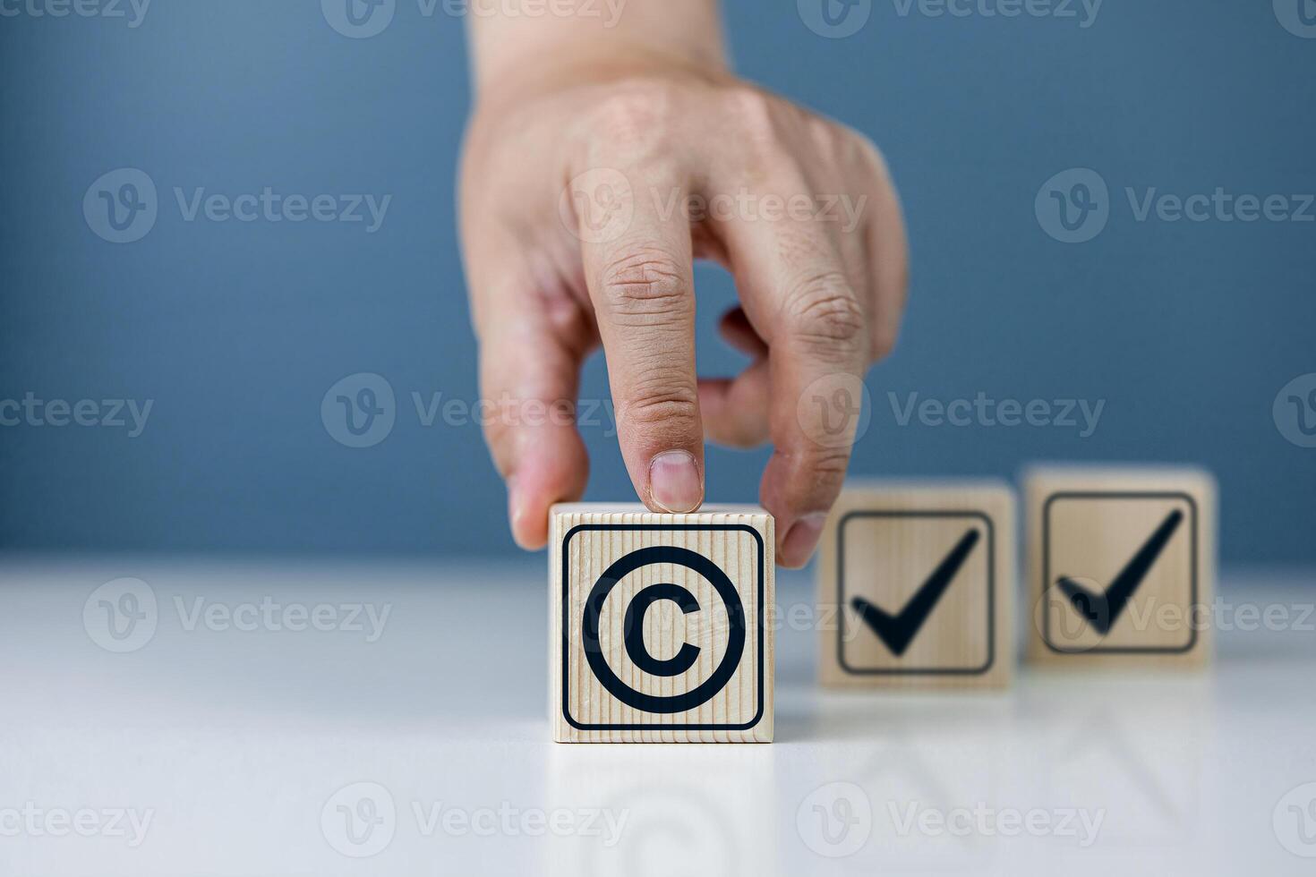 Copyright symbol or intellectual property rights of patentee on wooden cube. Business concept of author rights, designer, and trademark license photo