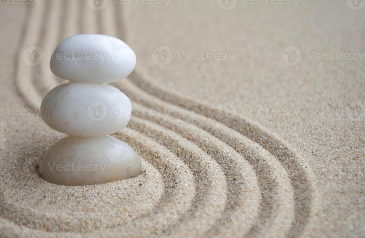 White zen stones on sand with customizable space for text photo