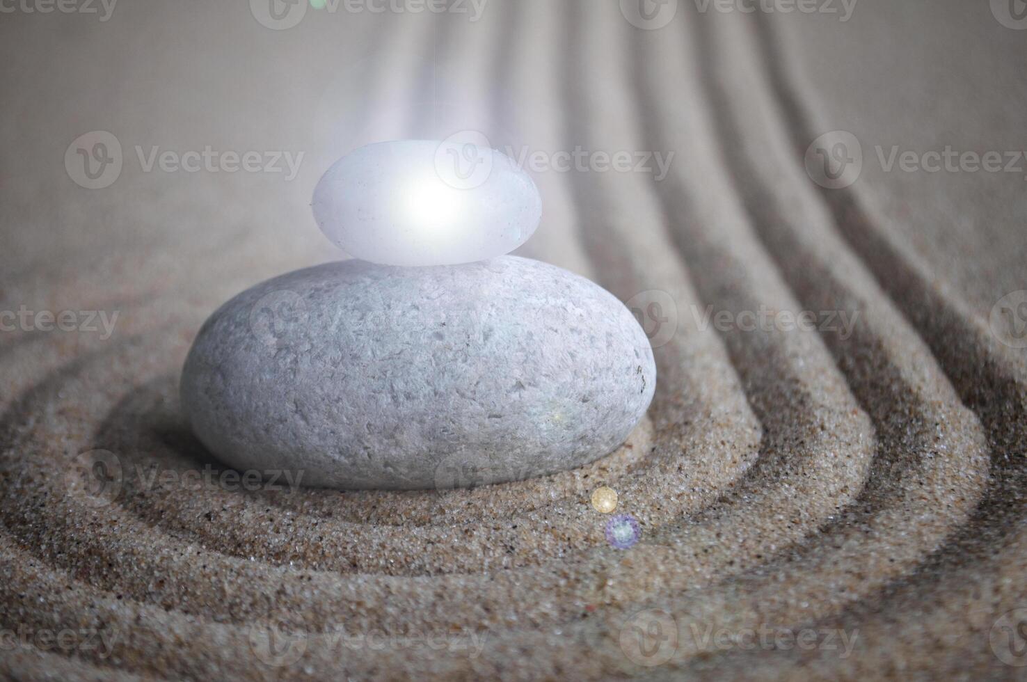 Zen stones with shining light on sand with customizable space for text or message photo
