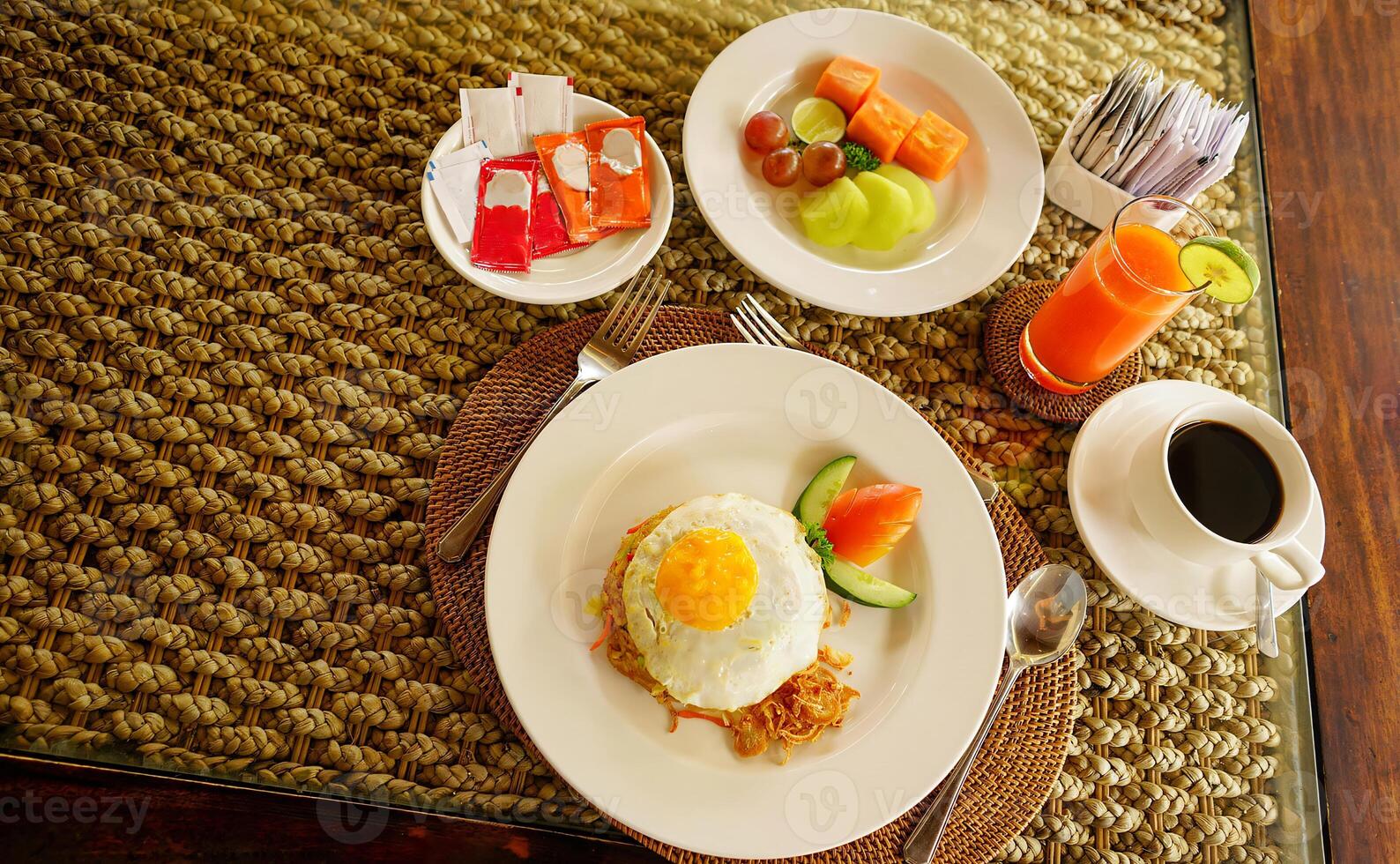 Breakfast at hotel style at Asian style hotel by the swimming pool. Table with delicious food by the beautiful blue pool travel in resort on sunny summer day. Rest and vacation in luxury hotel photo