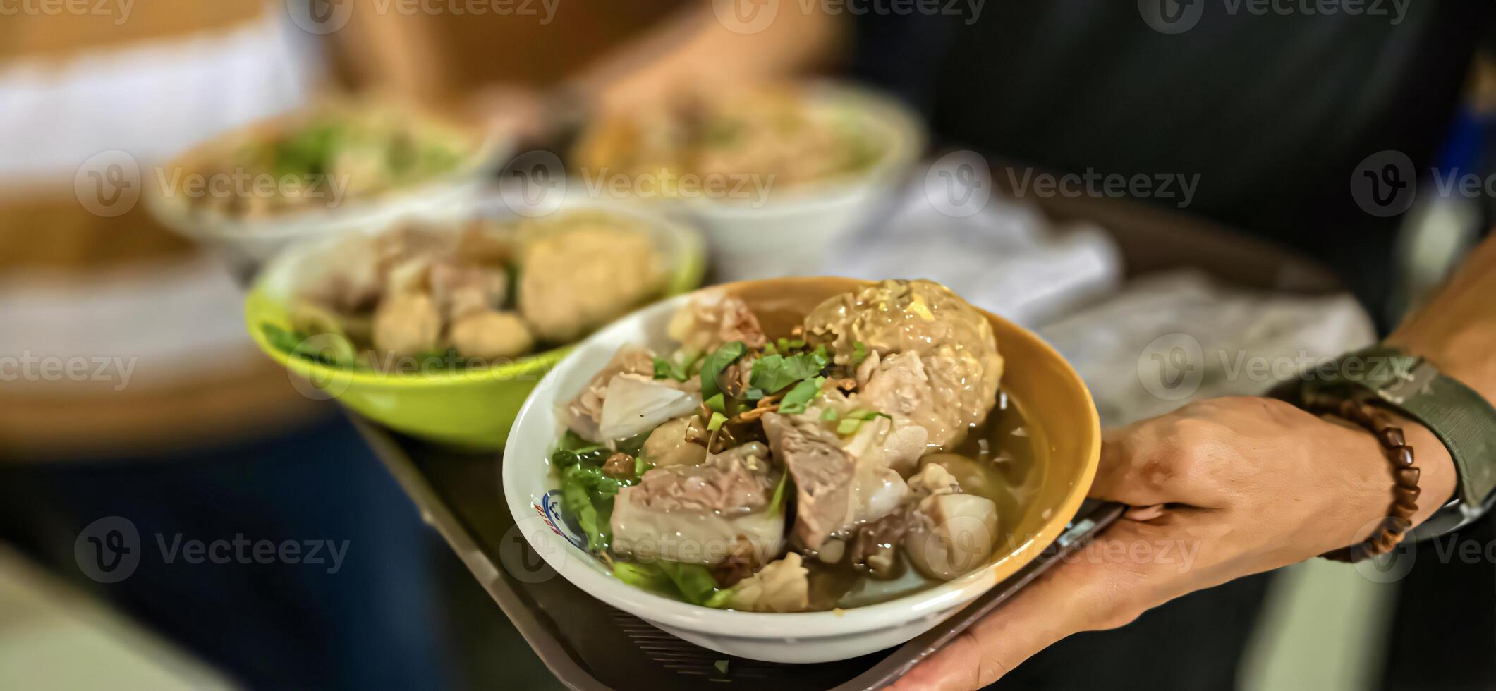 Giant Bakso, or Jumbo meatball is indonesian meatball style served with beef broth soup and noodle springkled with fried onion and spring onion coupled with chili sauce on the top photo