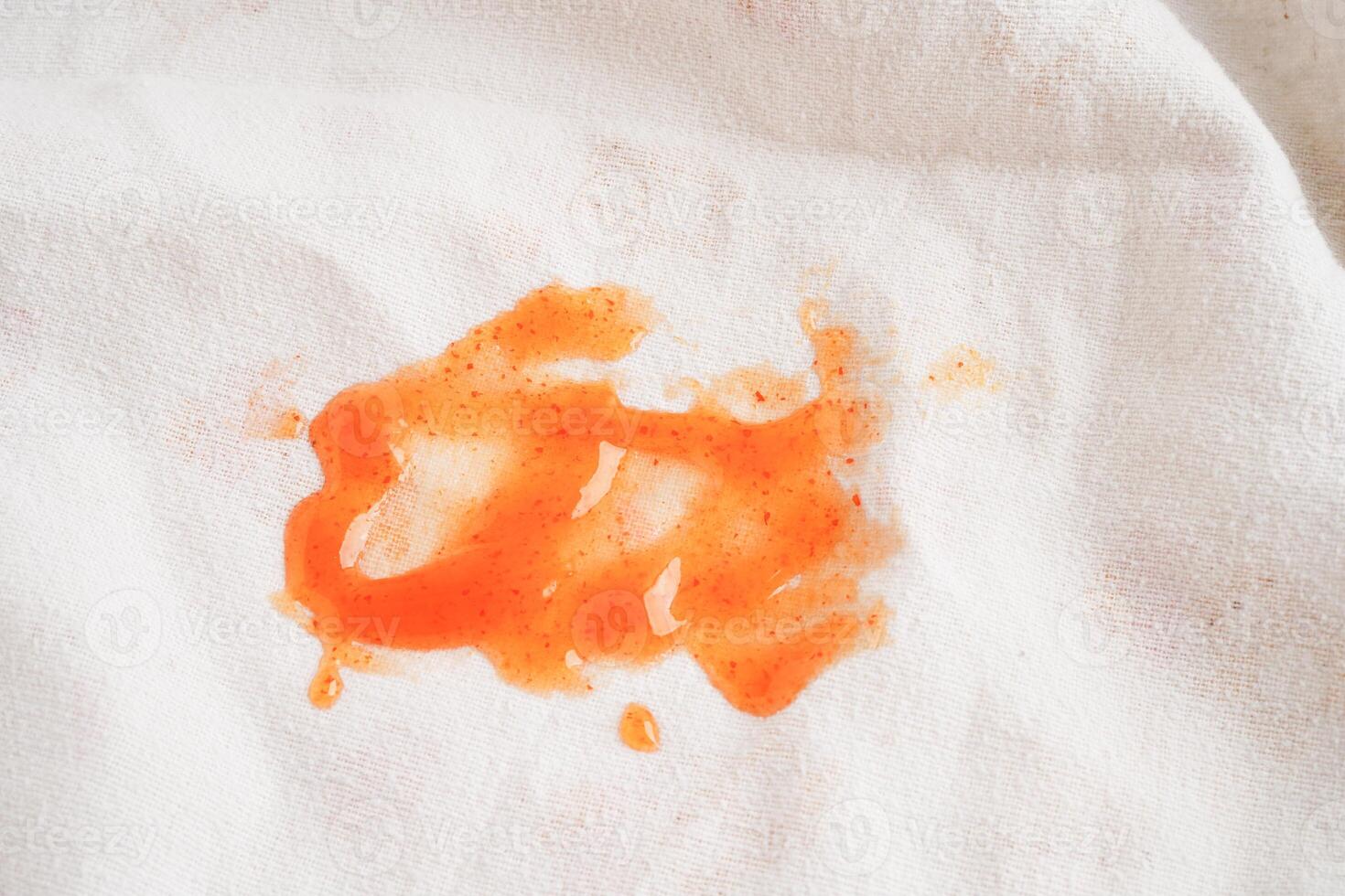 Dirty tomato sauce stain or ketchup on cloth to wash with washing powder, cleaning housework concept. photo