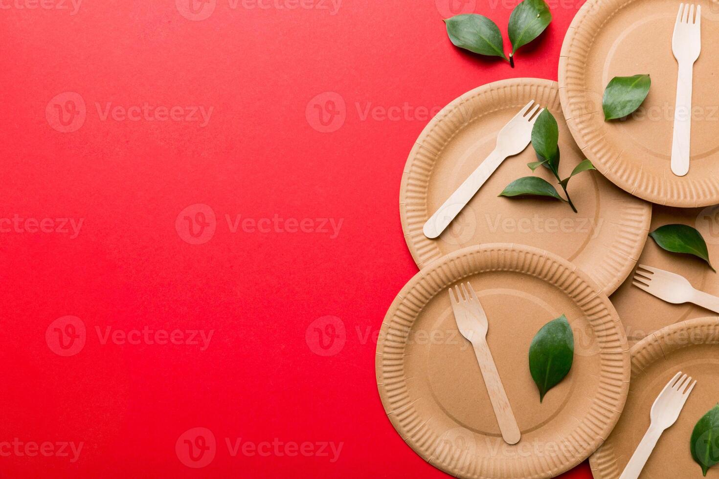 set of empty reusable disposable eco-friendly plates, cups, utensils on light white colored table background. top view. Biodegradable craft dishes. Recycling concept. Close-up photo