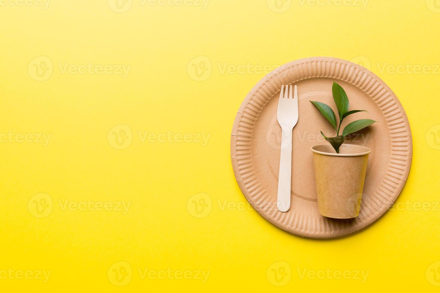 set of empty reusable disposable eco-friendly plates, cups, utensils on light white colored table background. top view. Biodegradable craft dishes. Recycling concept. Close-up photo