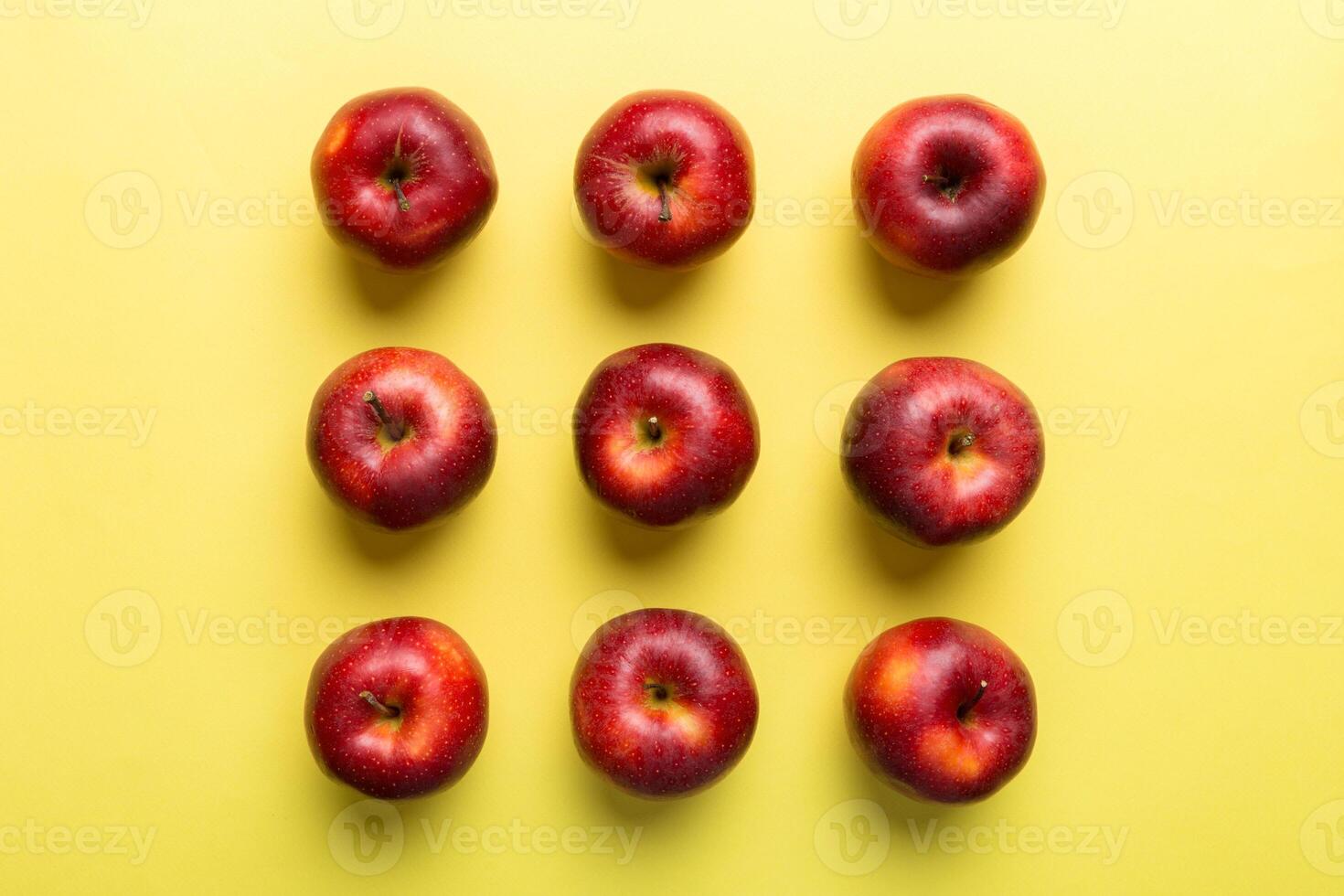Many red apples on colored background, top view. Autumn pattern with fresh apple above view photo