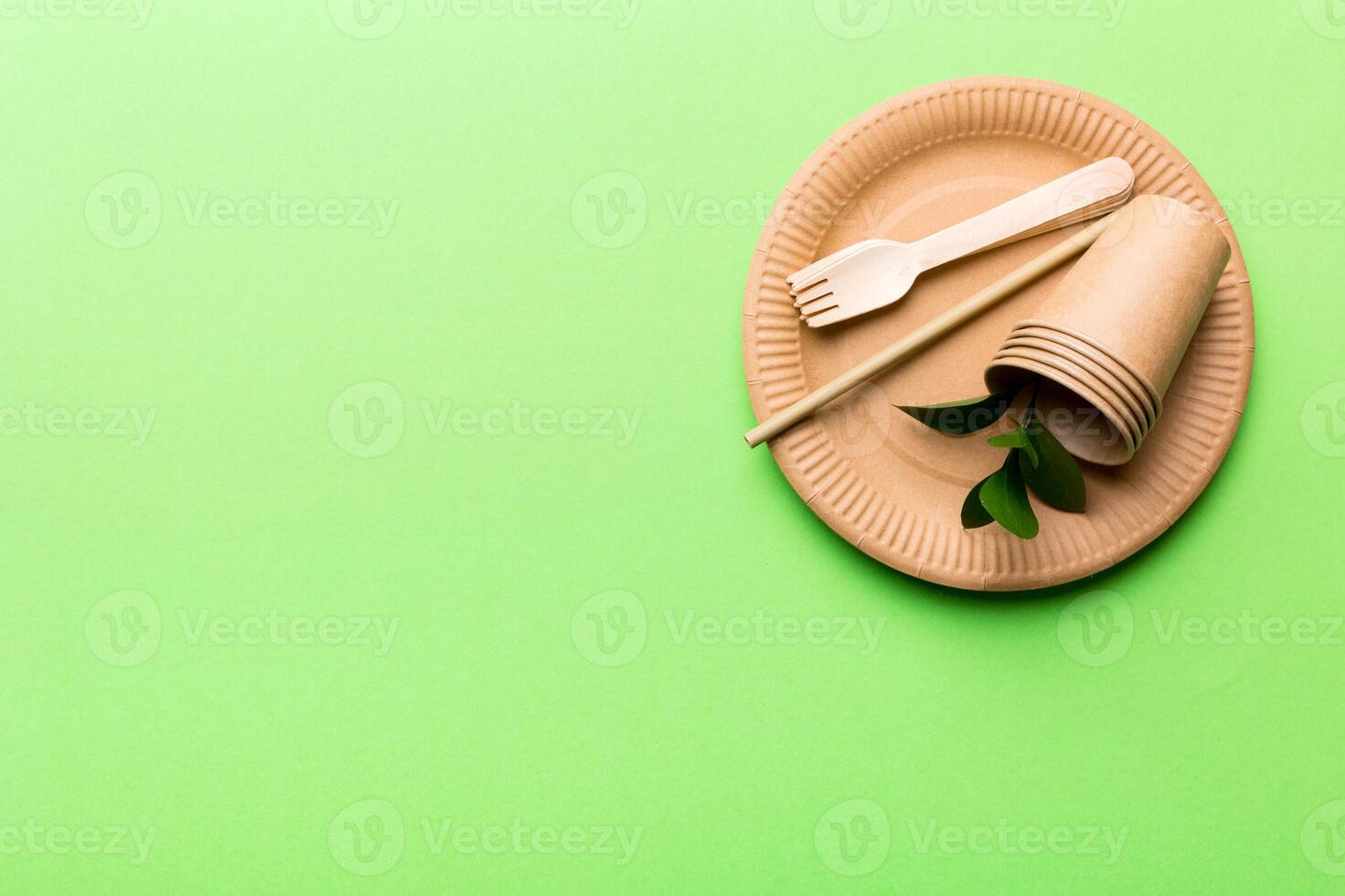set of empty reusable disposable eco-friendly plates, cups, utensils on light white colored table background. top view. Biodegradable craft dishes. Recycling concept. Close-up photo