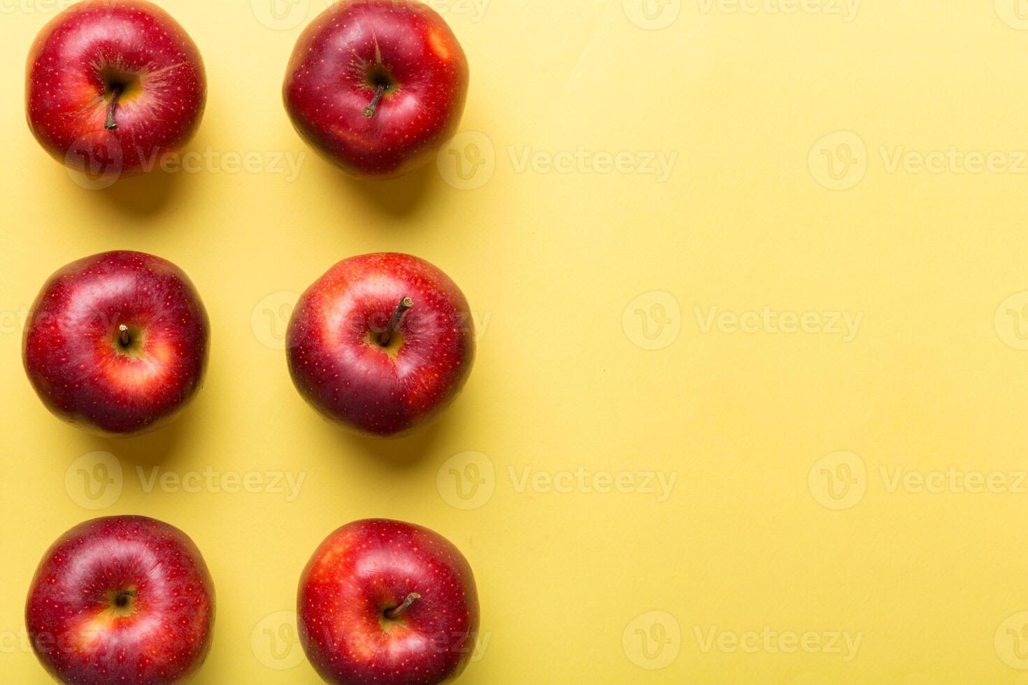 Many red apples on colored background, top view. Autumn pattern with fresh apple above view with copy space for design or text photo