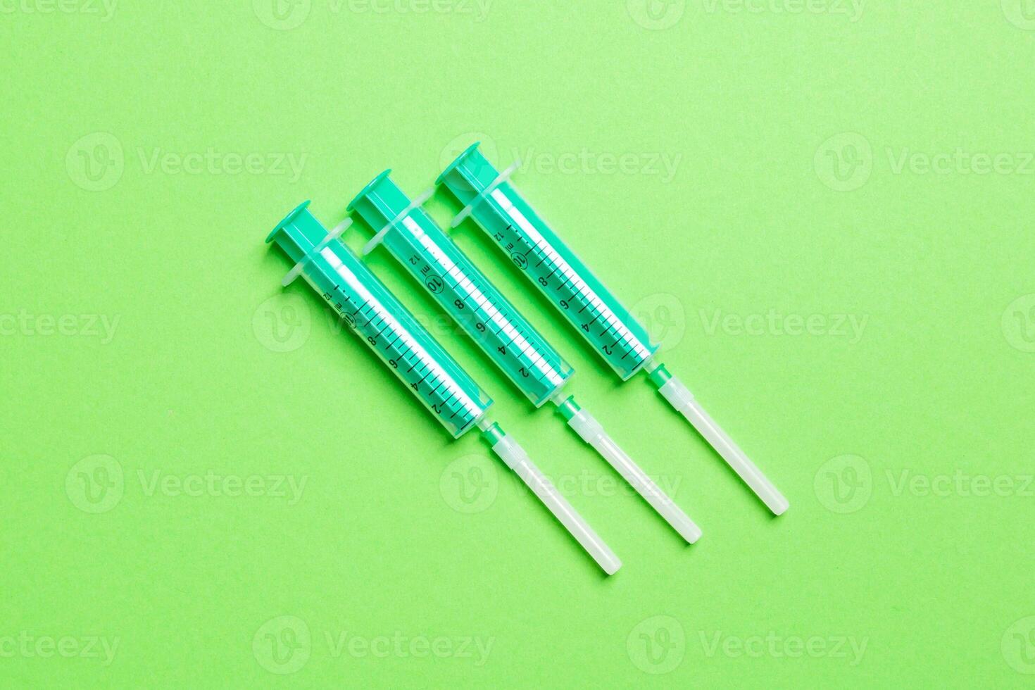 Top view of medical syringes on colorful background with copy space. Injection equipment concept photo