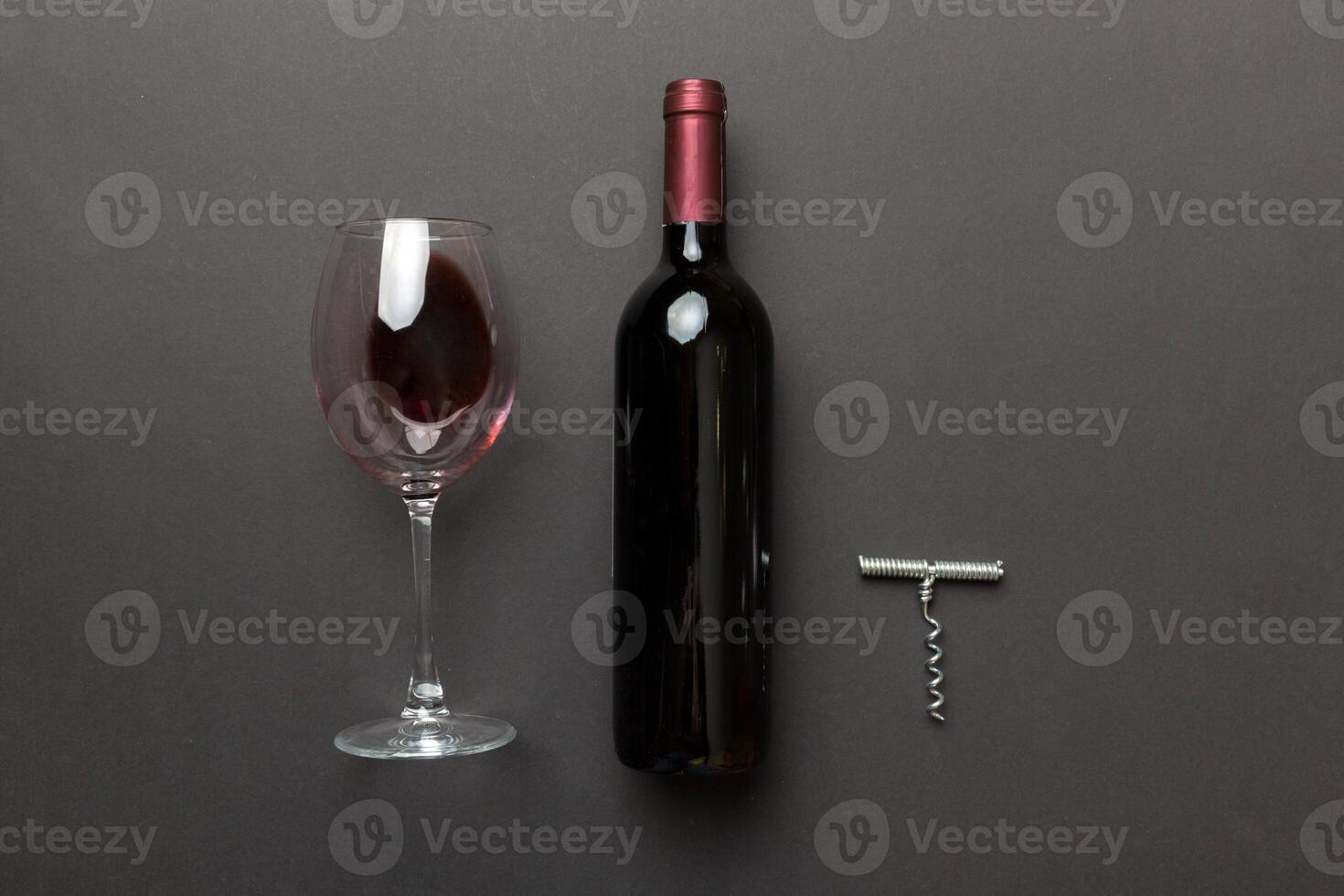 Flat lay composition with corkscrew, bottle of wine and elegant glass on colored table. Flat lay, top view wth copy space photo