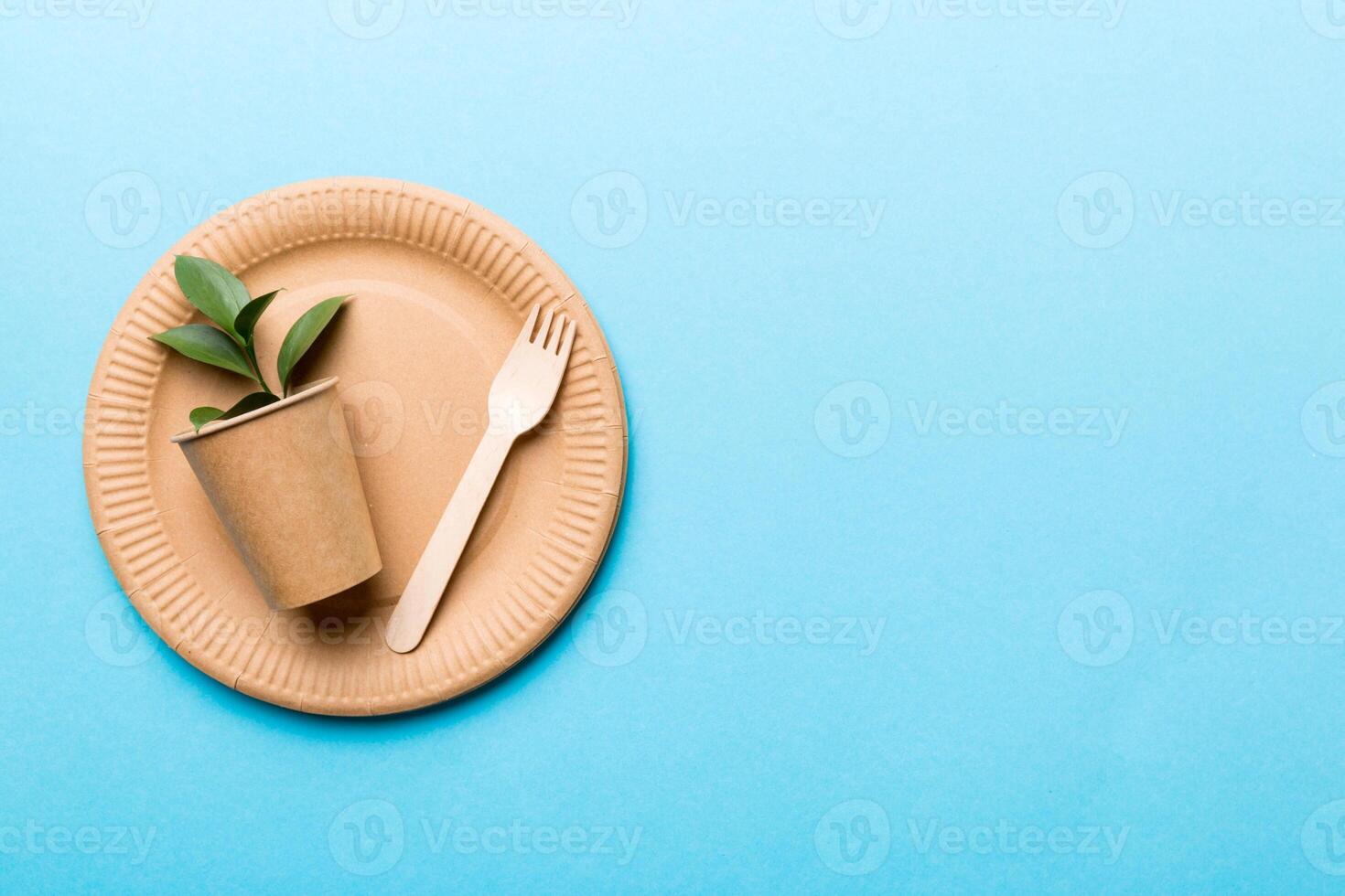 set of empty reusable disposable eco-friendly plates, cups, utensils on light white colored table background. top view. Biodegradable craft dishes. Recycling concept. Close-up photo