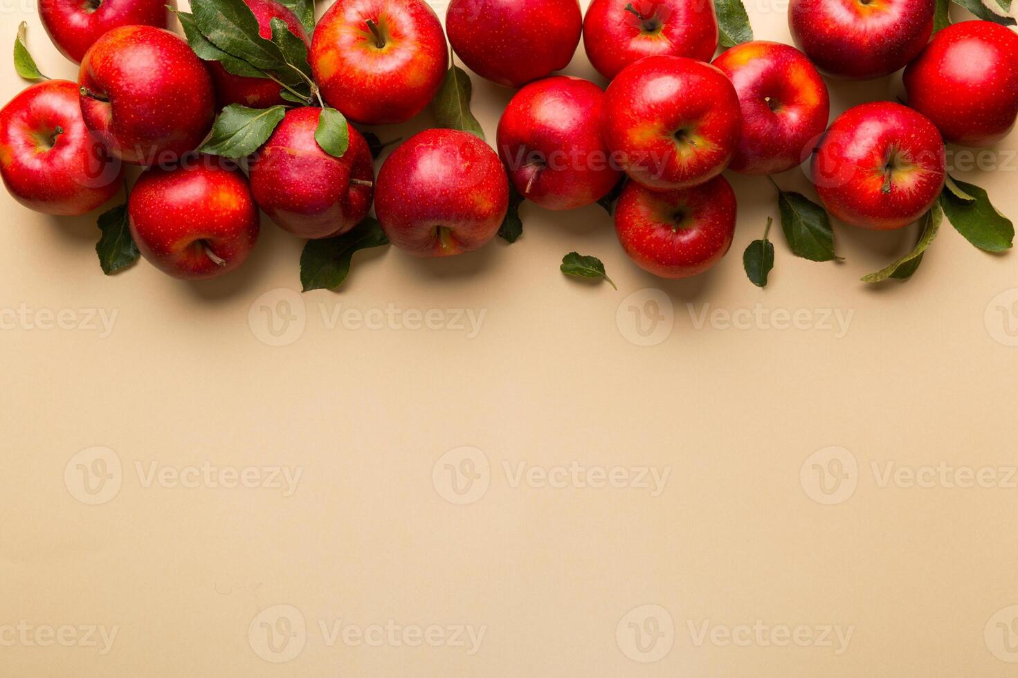Many red apples on colored background, top view. Autumn pattern with fresh apple above view with copy space for design or text photo